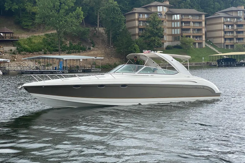  Yacht Photos Pics 2004 Formula 370ss boat on a lake with waterfront buildings in the background.