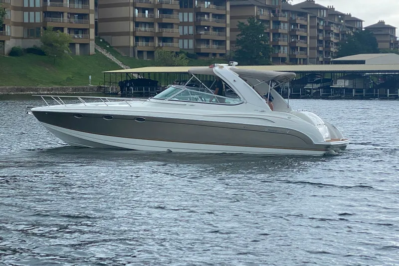  Yacht Photos Pics 2004 Formula 370ss boat cruising on a lake near waterfront buildings.