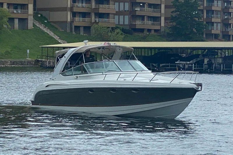  Yacht Photos Pics 2004 Formula 370ss boat cruising on a lake near waterfront buildings.