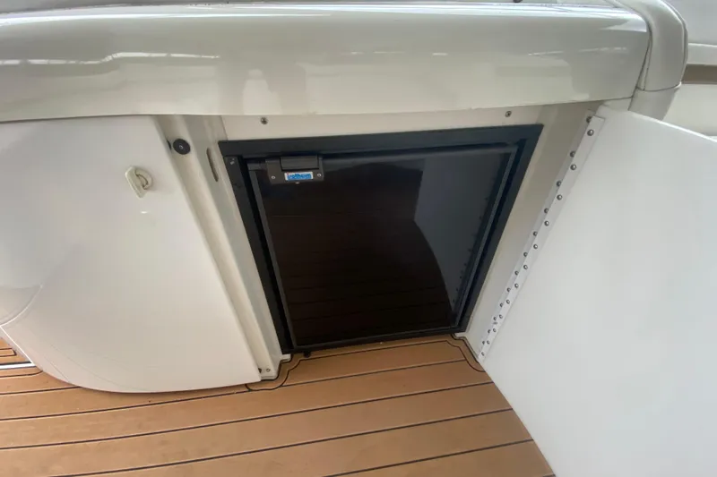  Yacht Photos Pics 2004 Formula 370ss boat interior with built-in refrigerator and wooden flooring.