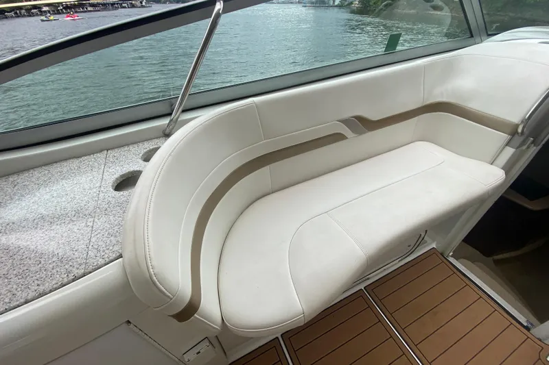 Yacht Photos Pics 2004 Formula 370ss boat interior with white seating and wood flooring by the water.