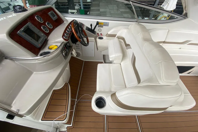  Yacht Photos Pics 2004 Formula 370ss boat interior with white leather seating and wooden dashboard.