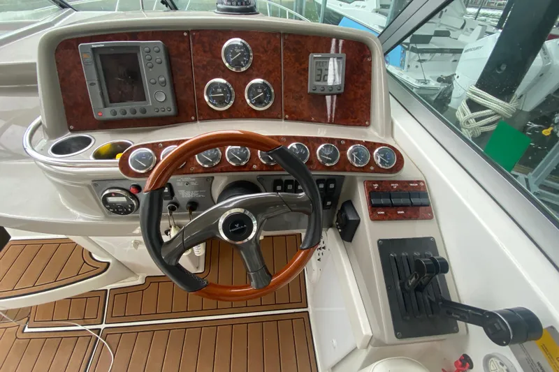  Yacht Photos Pics 2004 Formula 370ss boat dashboard with steering wheel, gauges, and navigation controls.