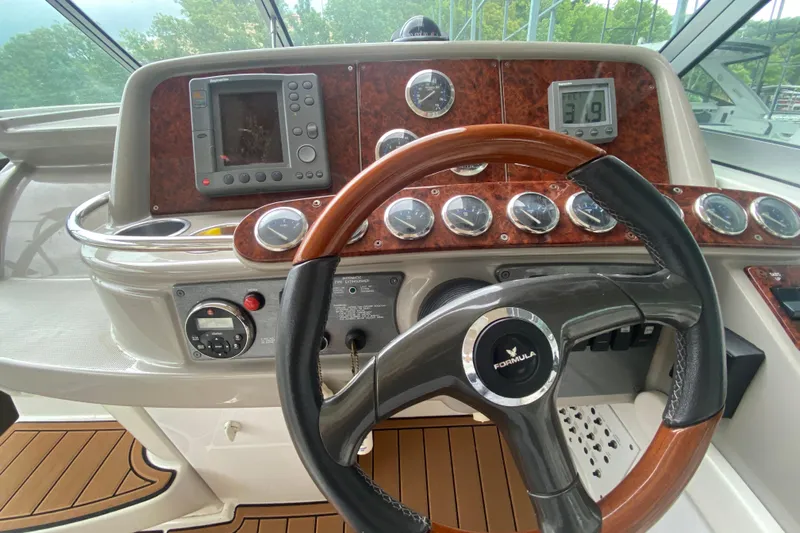  Yacht Photos Pics 2004 Formula 370ss boat dashboard with steering wheel and navigation instruments.
