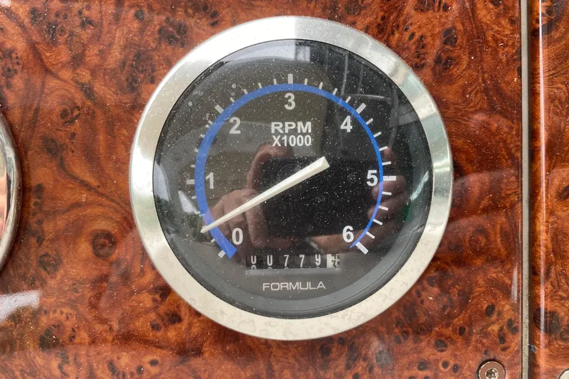  Yacht Photos Pics Close-up of a 2004 Formula 370ss RPM gauge on a wood grain dashboard.