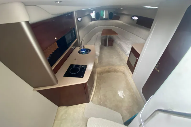  Yacht Photos Pics Interior of a 2004 Formula 370ss boat with kitchenette and seating area.
