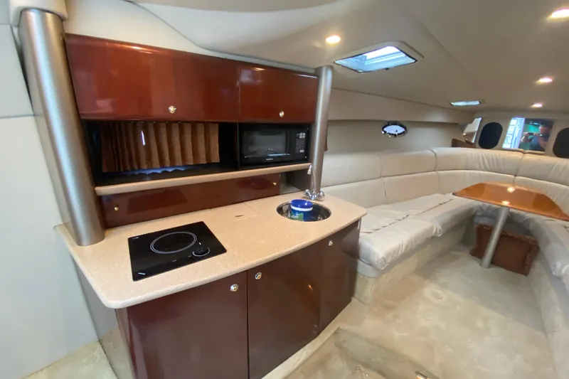  Yacht Photos Pics Luxurious interior of a 2004 Formula 370ss boat with kitchenette and seating area.