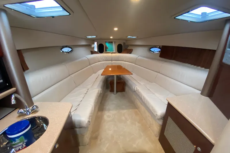  Yacht Photos Pics Interior of 2004 Formula 370ss boat with white seating and wooden table.