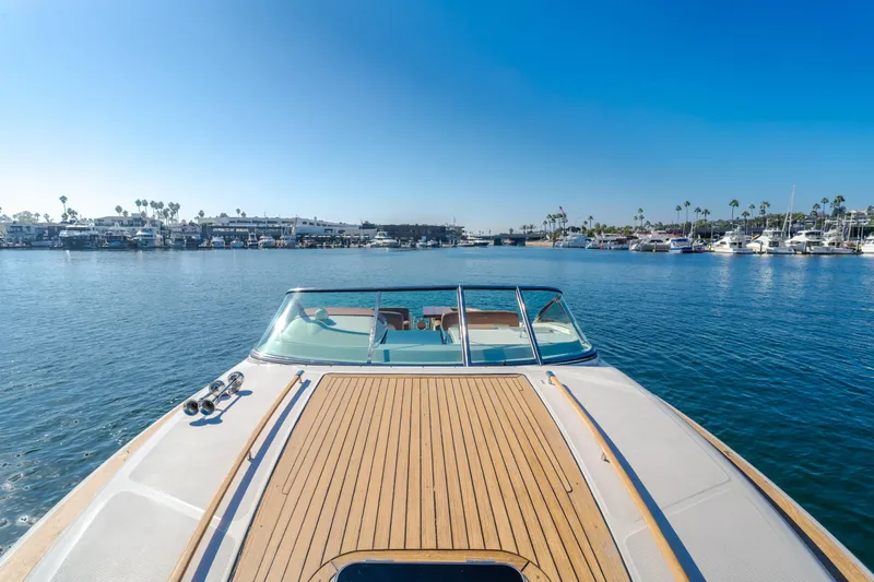 Dream Chaser Yacht Photos Pics 2006 Chris-Craft Corsair 36 yacht on calm water, clear blue sky, marina view.