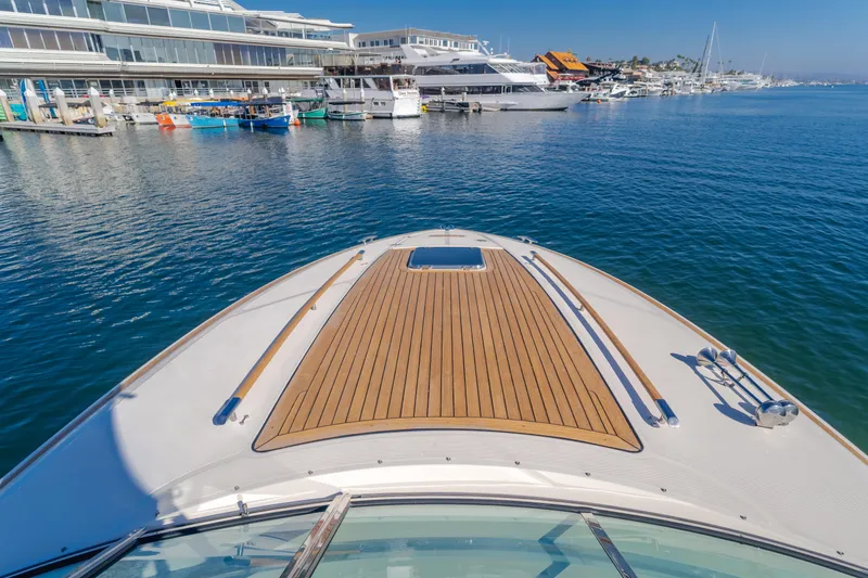 Dream Chaser Yacht Photos Pics 2006 Chris-Craft Corsair 36 yacht docked in a marina, showcasing sleek wooden deck.