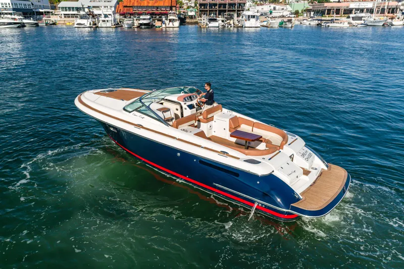 Dream Chaser Yacht Photos Pics 2006 Chris-Craft Corsair 36 cruising in a marina, showcasing elegant design and luxury features.