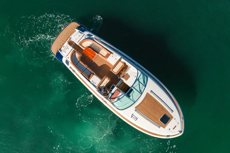 Dream Chaser Yacht Photos Pics Aerial view of 2006 Chris-Craft Corsair 36 boat on clear green water.