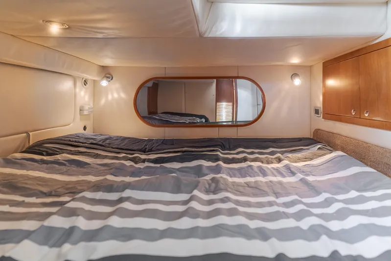 Dream Chaser Yacht Photos Pics Luxurious cabin interior of 2006 Chris-Craft Corsair 36 with striped bedding and ambient lighting.