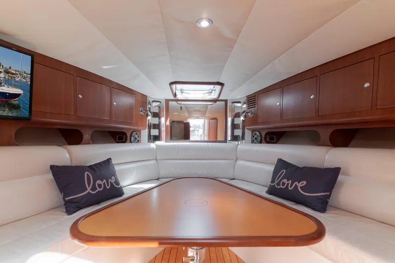 Dream Chaser Yacht Photos Pics Luxurious interior of 2006 Chris-Craft Corsair 36 with white seating and wooden accents.