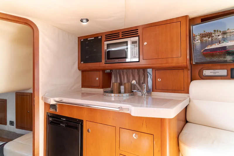 Dream Chaser Yacht Photos Pics Luxurious 2006 Chris-Craft Corsair 36 yacht interior with kitchenette and modern amenities.