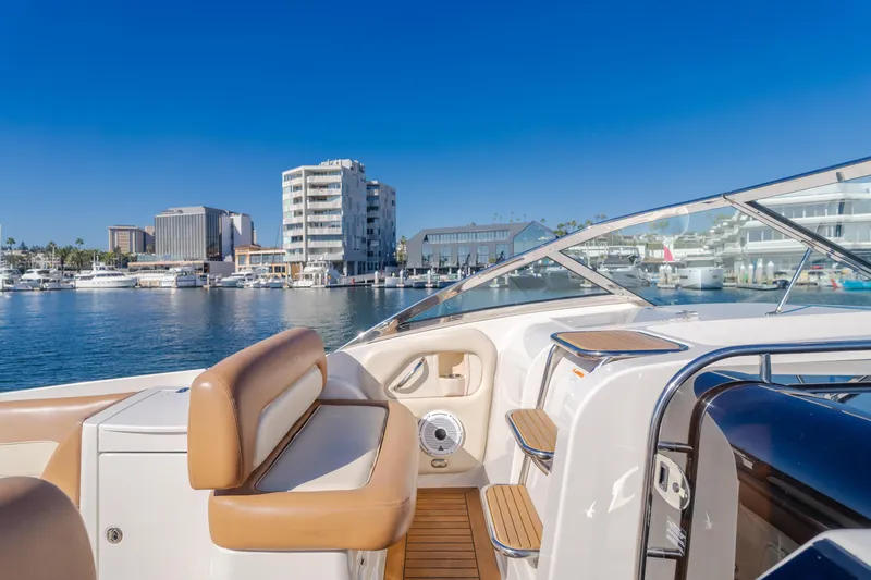 Dream Chaser Yacht Photos Pics 2006 Chris-Craft Corsair 36 yacht interior with marina view, clear blue sky.