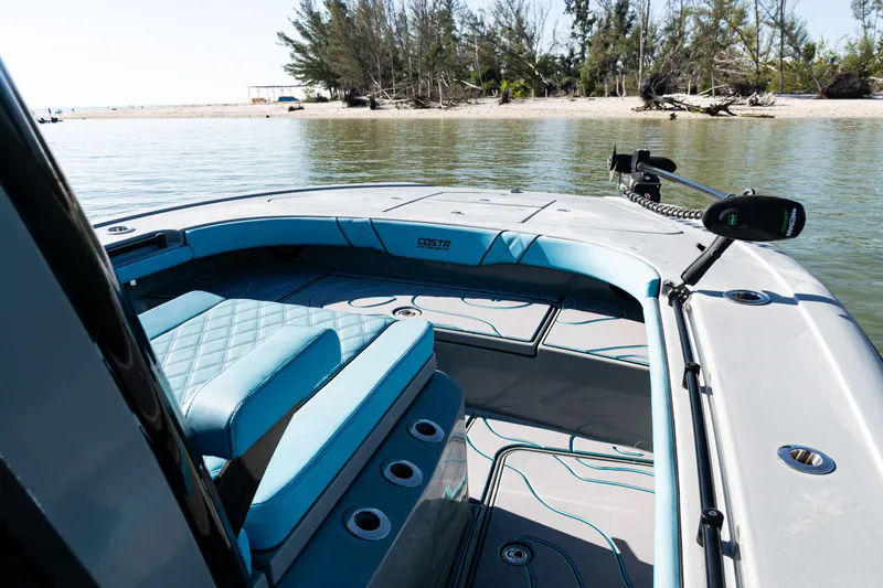  Yacht Photos Pics 2022 Costa Custom Boats 264 on calm water near a sandy shore.