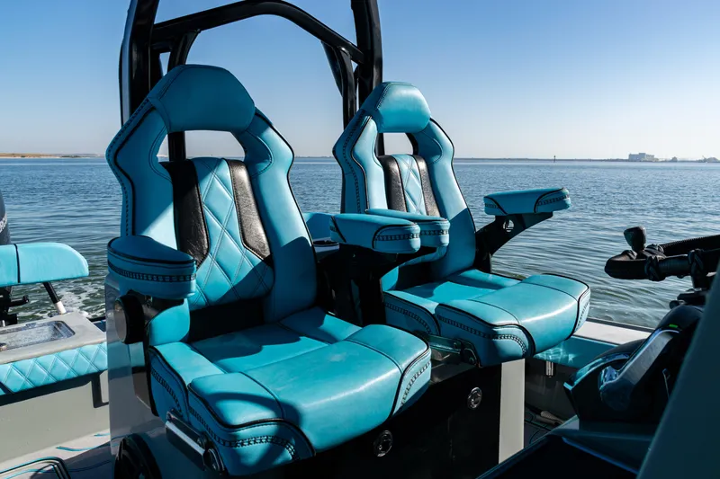  Yacht Photos Pics Luxurious blue seating on 2022 Costa Custom Boats 264, overlooking serene water.