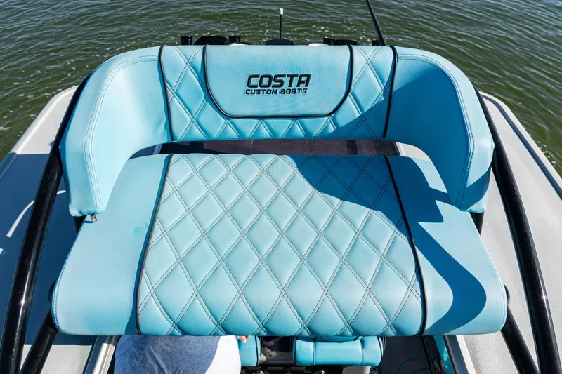  Yacht Photos Pics Blue seating on 2022 Costa Custom Boats 264, featuring diamond stitching and logo.