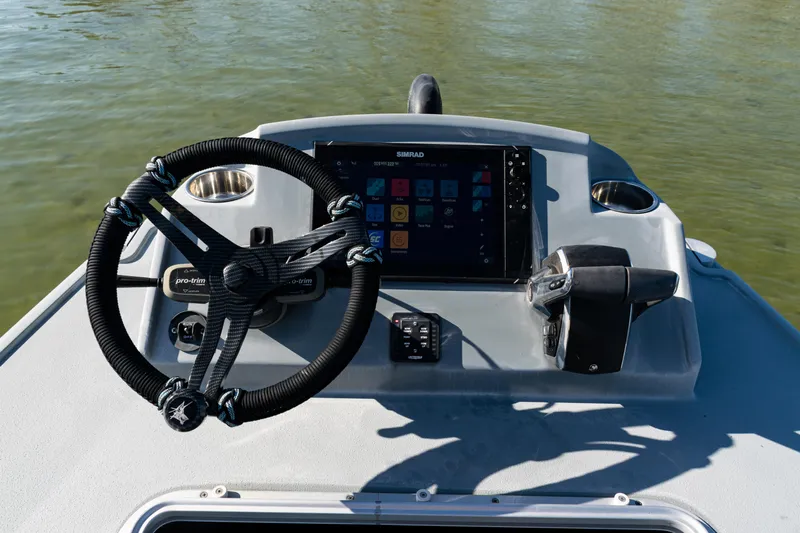  Yacht Photos Pics Steering console of 2022 Costa Custom Boats 264 with navigation display and controls.