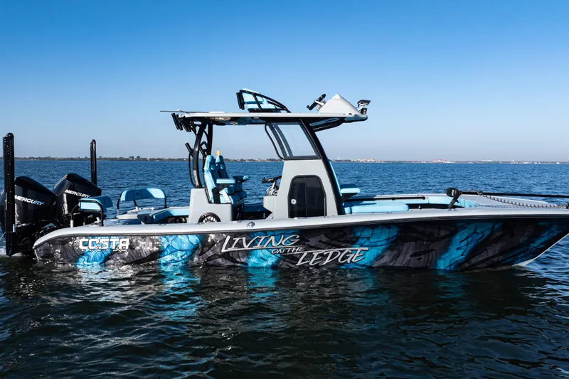  Yacht Photos Pics 2022 Costa Custom Boats 264 on water, vibrant blue design, "Living on the Ledge" graphics.