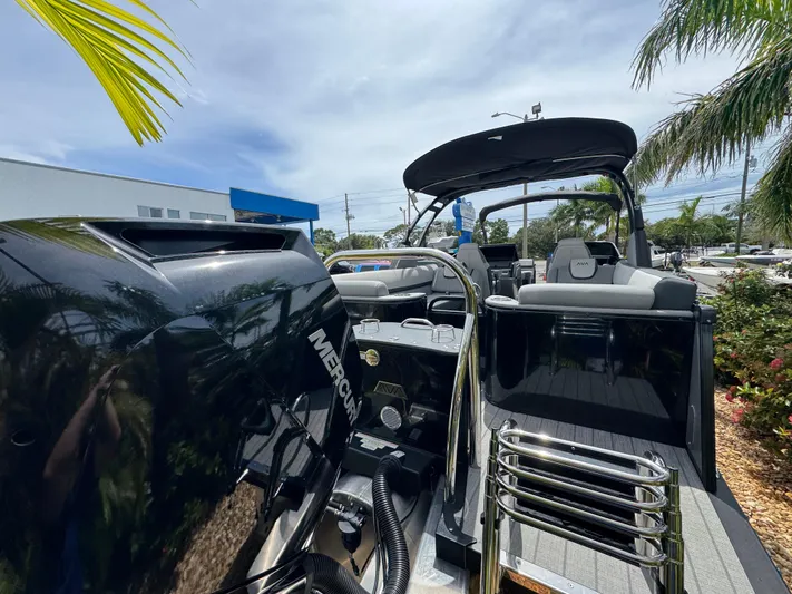  Yacht Photos Pics 2025 Avalon Catalina Platinum Quad Lounge boat with Mercury engine, docked under palm trees.