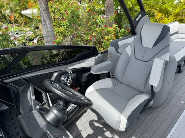  Yacht Photos Pics 2025 Avalon Catalina Platinum Quad Lounge interior with luxurious captain's chair and sleek dashboard.