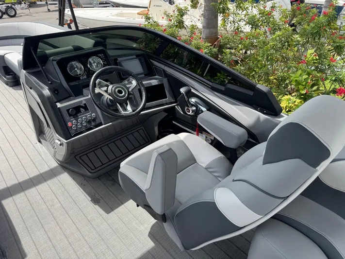  Yacht Photos Pics 2025 Avalon Catalina Platinum Quad Lounge boat interior with modern steering console and seating.