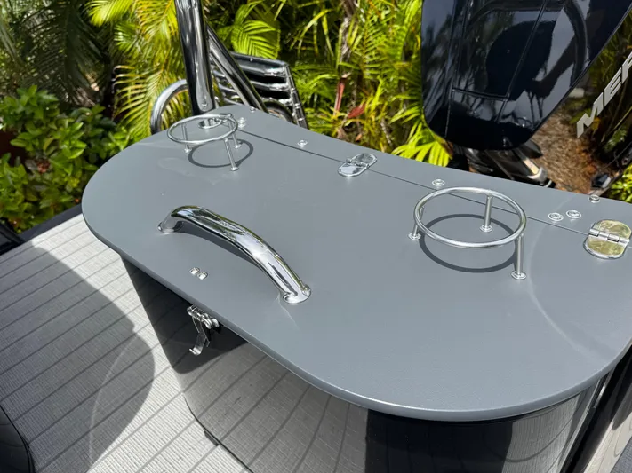  Yacht Photos Pics 2025 Avalon Catalina Platinum Quad Lounge boat with sleek gray surface and cup holders.