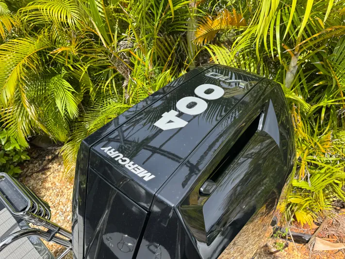  Yacht Photos Pics Mercury outboard motor on 2025 Avalon Catalina Platinum Quad Lounge, surrounded by lush greenery.