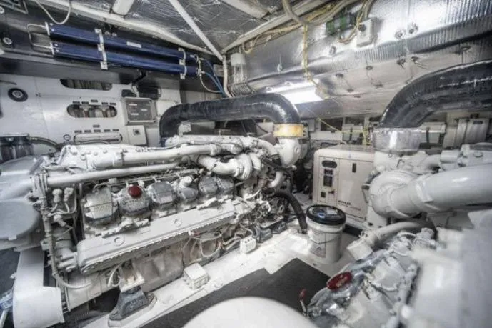 Chopin Yacht Photos Pics Engine room of a 2007 Pershing 62' yacht, showcasing complex machinery and piping.