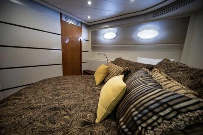Chopin Yacht Photos Pics Luxurious bedroom interior of 2007 Pershing 62' yacht with elegant bedding and ambient lighting.