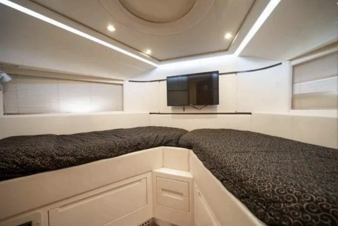 Chopin Yacht Photos Pics Luxurious interior of 2007 Pershing 62' yacht with modern bedding and wall-mounted TV.