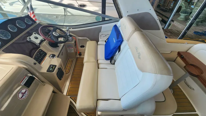 Back In The Game Yacht Photos Pics Interior of 2008 Sea Ray 310 Sundancer boat with beige seating and control panel.