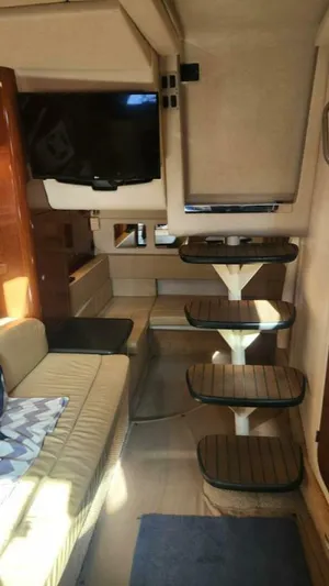 Back In The Game Yacht Photos Pics Interior of 2008 Sea Ray 310 Sundancer with cozy seating and wooden steps.