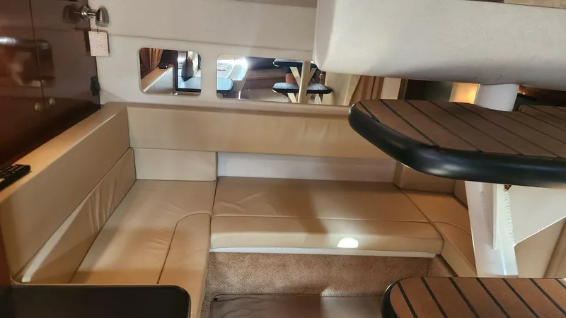 Back In The Game Yacht Photos Pics 2008 Sea Ray 310 Sundancer interior with beige seating and wooden accents.