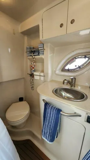 Back In The Game Yacht Photos Pics 2008 Sea Ray 310 Sundancer bathroom with sink, toilet, and storage cabinets.