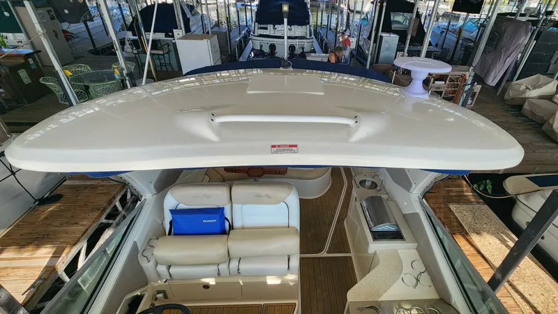 Back In The Game Yacht Photos Pics 2008 Sea Ray 310 Sundancer boat interior with seating and helm, docked in marina.