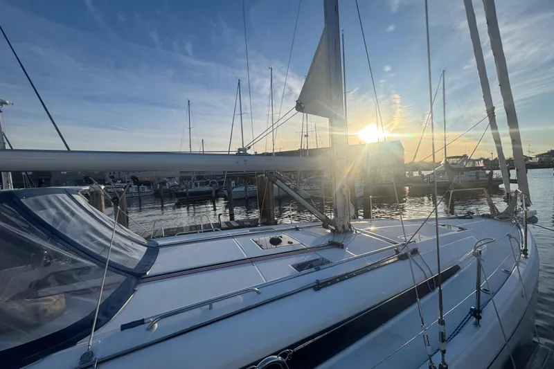Sway Yacht Photos Pics 2023 Beneteau Oceanis 40.1 sailboat docked at sunset, marina view.