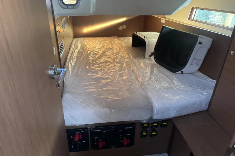 Sway Yacht Photos Pics 2023 Beneteau Oceanis 40.1 cabin interior with bed and control panels.