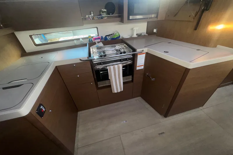 Sway Yacht Photos Pics 2023 Beneteau Oceanis 40.1 yacht kitchen with modern appliances and sleek wood cabinetry.