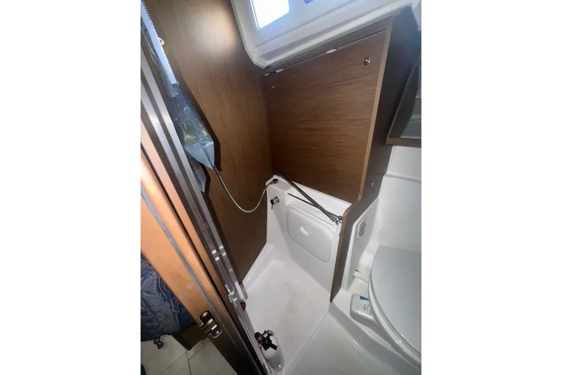 Sway Yacht Photos Pics 2023 Beneteau Oceanis 40.1 yacht bathroom with wooden cabinetry and modern fixtures.