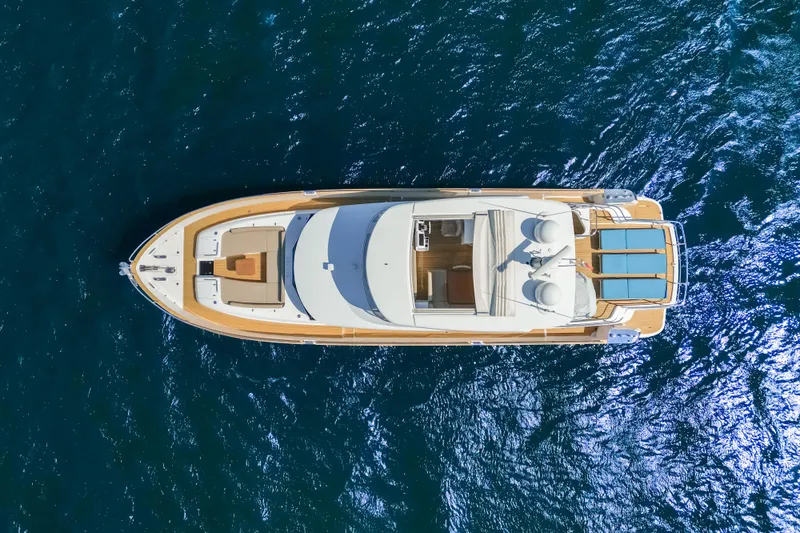 Izi Yacht Photos Pics Overhead view of 2017 Azimut Magellano 66 yacht on blue ocean water.