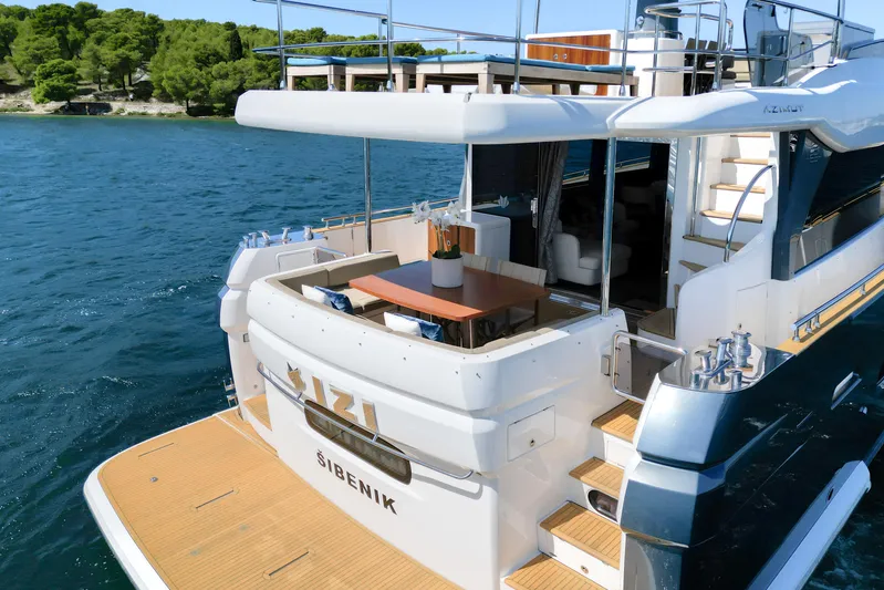 Izi Yacht Photos Pics Azimut Magellano 66 yacht, 2017 model, docked on serene blue waters.