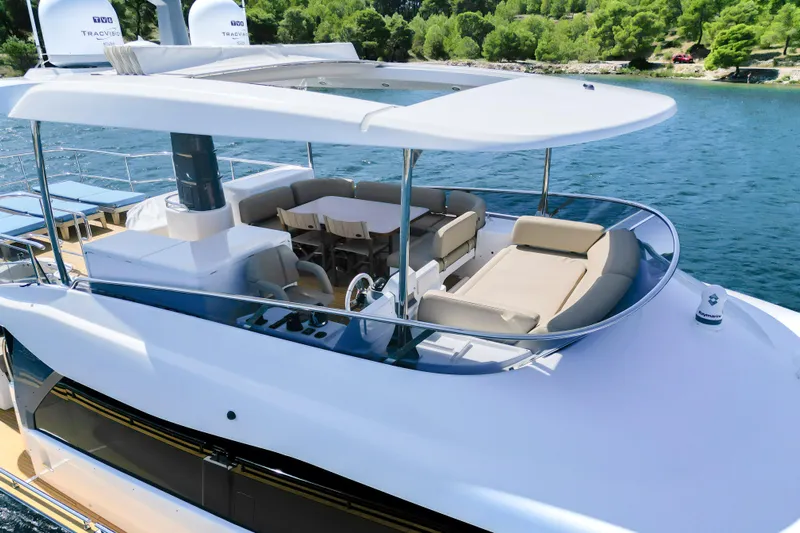 Izi Yacht Photos Pics Luxurious 2017 Azimut Magellano 66 yacht with spacious outdoor seating and dining area.