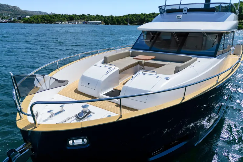 Izi Yacht Photos Pics Azimut Magellano 66 yacht, 2017 model, cruising on a sunny day with scenic backdrop.