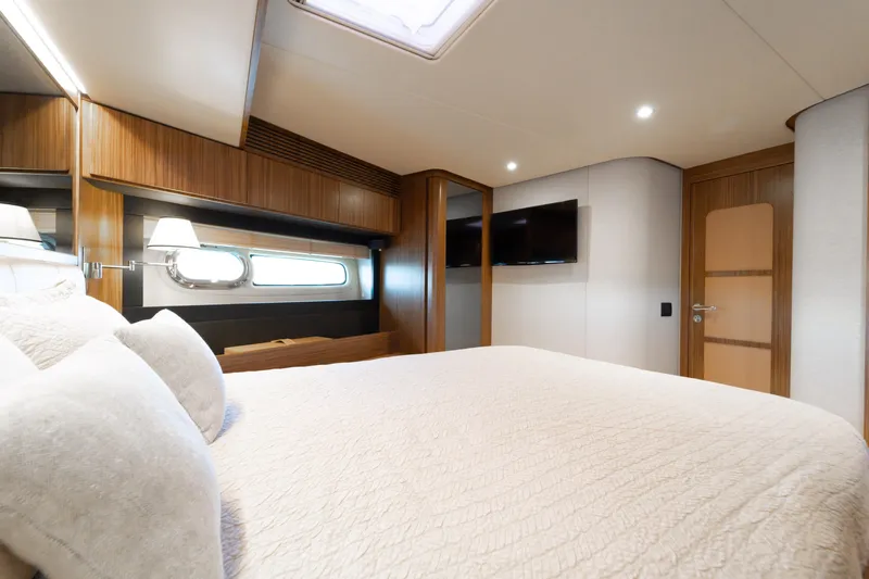 Izi Yacht Photos Pics Luxurious bedroom interior of 2017 Azimut Magellano 66 yacht with modern design and cozy ambiance.