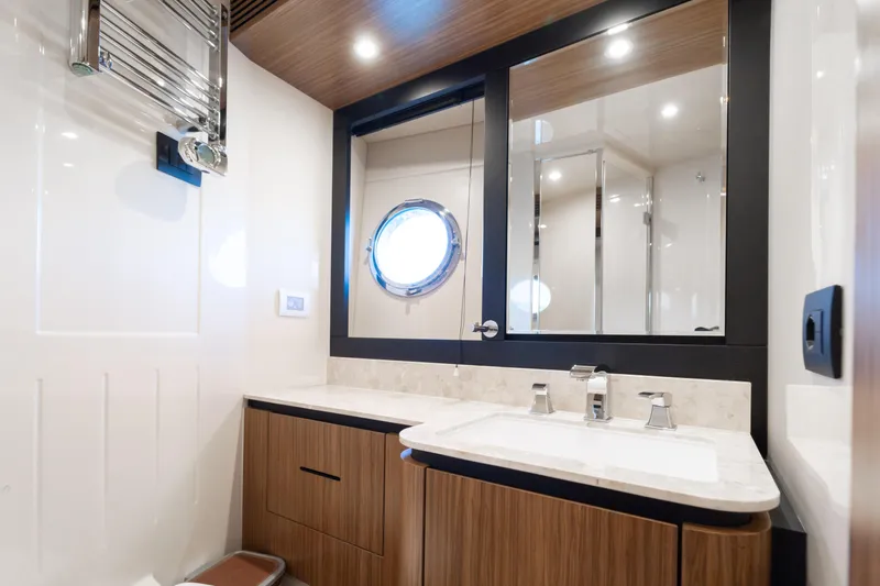 Izi Yacht Photos Pics Luxurious bathroom interior of 2017 Azimut Magellano 66 yacht with modern fixtures.