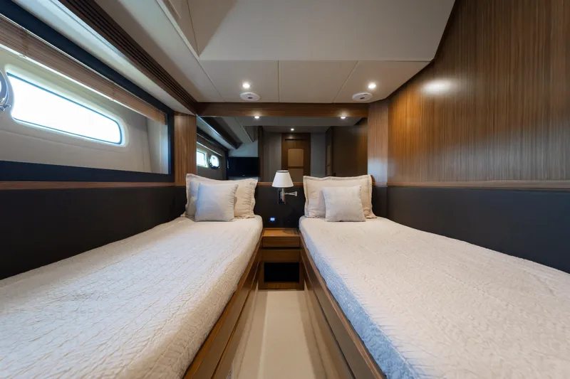 Izi Yacht Photos Pics Twin cabin interior of 2017 Azimut Magellano 66 yacht, featuring modern design and cozy bedding.