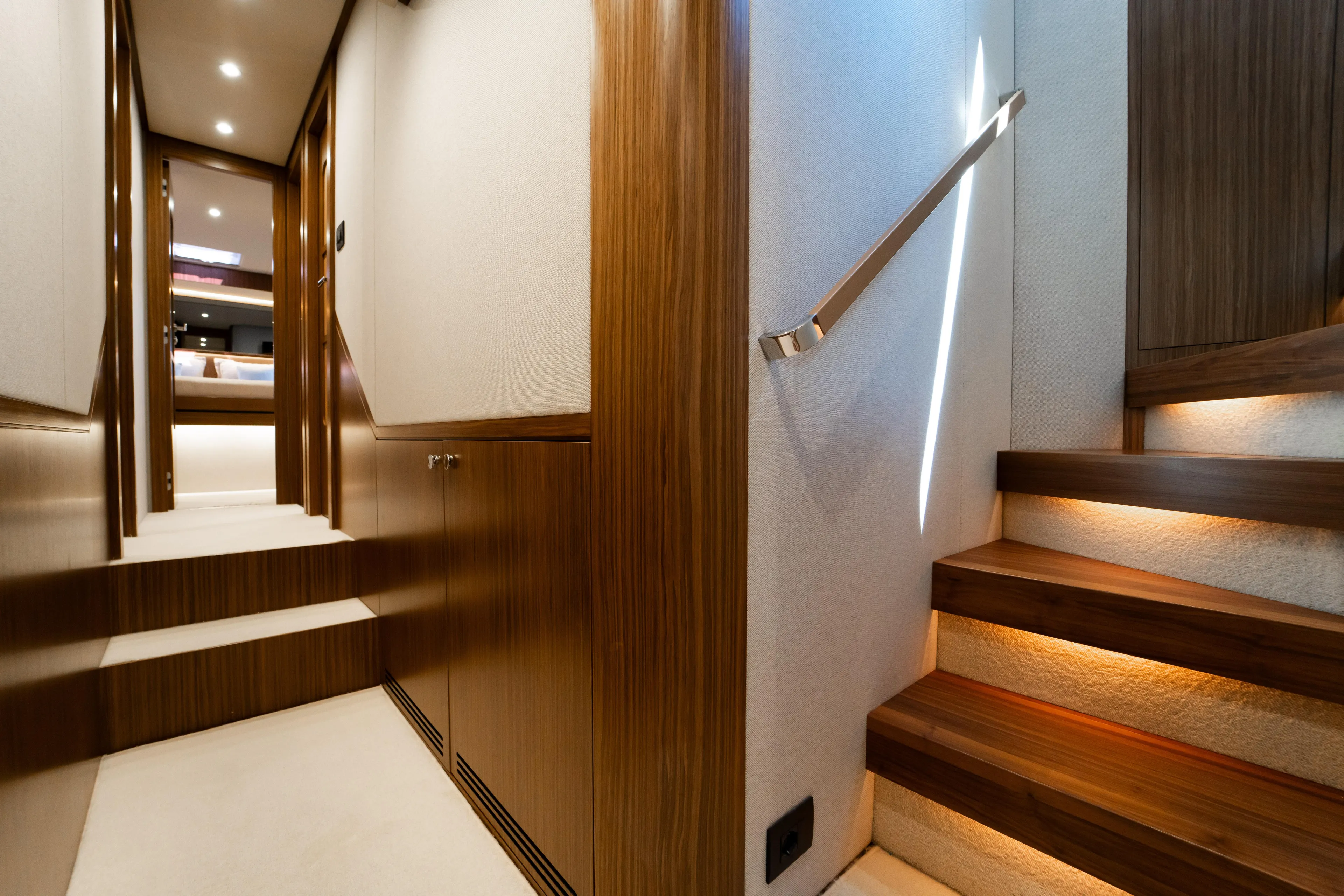 Izi Yacht Photos Pics Luxurious interior of 2017 Azimut Magellano 66 yacht with elegant wooden stairs and hallway.